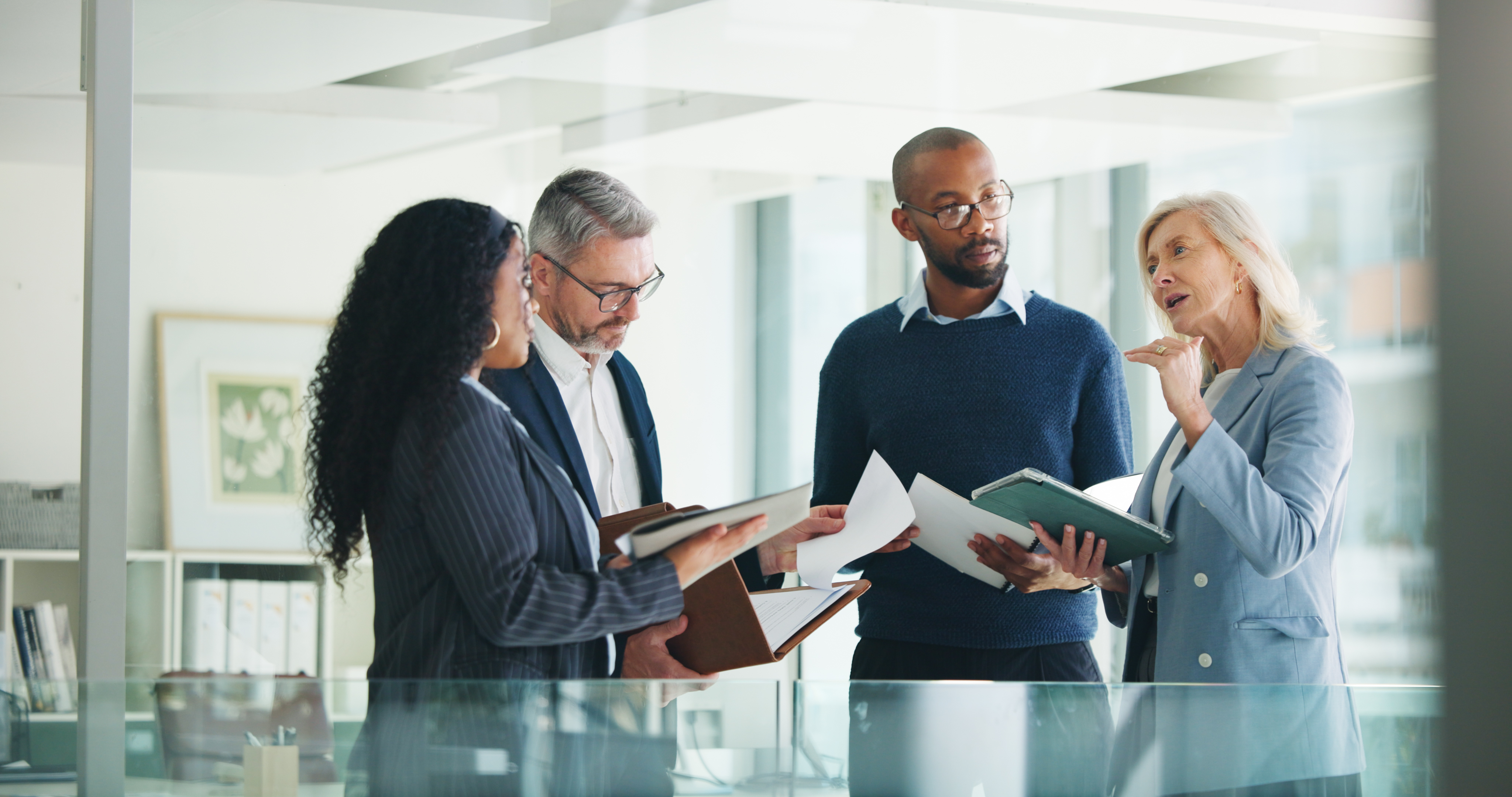 Business, documents and people with meeting discussion for finance trends, policy decision or update. Financial managers, report and feedback in office for investment strategy or risk management team